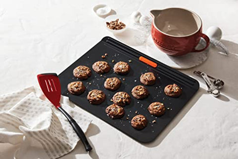 Le Creuset Revolution slotted spatula with nylon edge for cleanly sliding under foods.