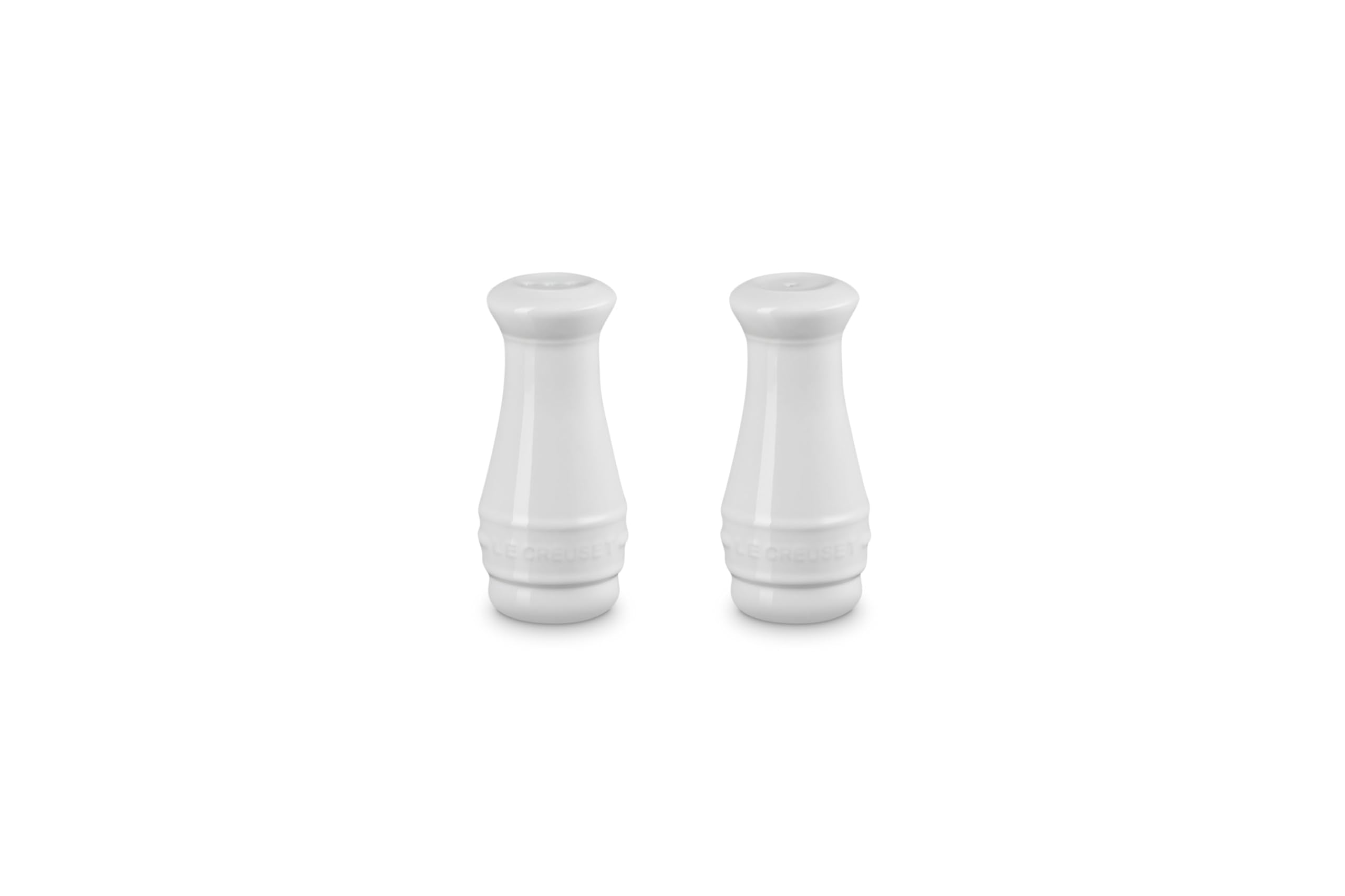Le Creuset white salt and pepper shakers—side view, durable stoneware for daily use.