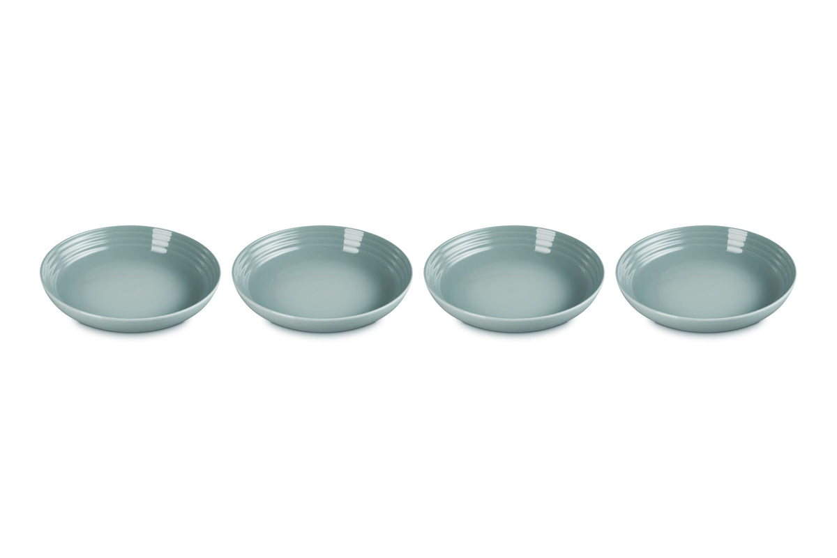 Le Creuset Sea Salt pasta bowls on table show vibrant color and sturdy construction for everyday meals.