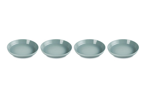 Le Creuset Sea Salt pasta bowls on table show vibrant color and sturdy construction for everyday meals.