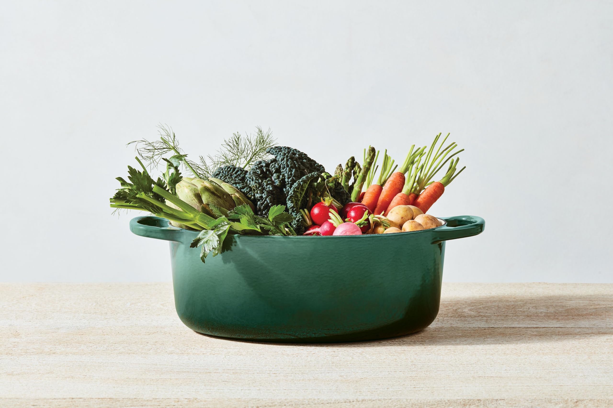 Le Creuset Signature Oval Dutch Oven on a stove top, ready for cooking