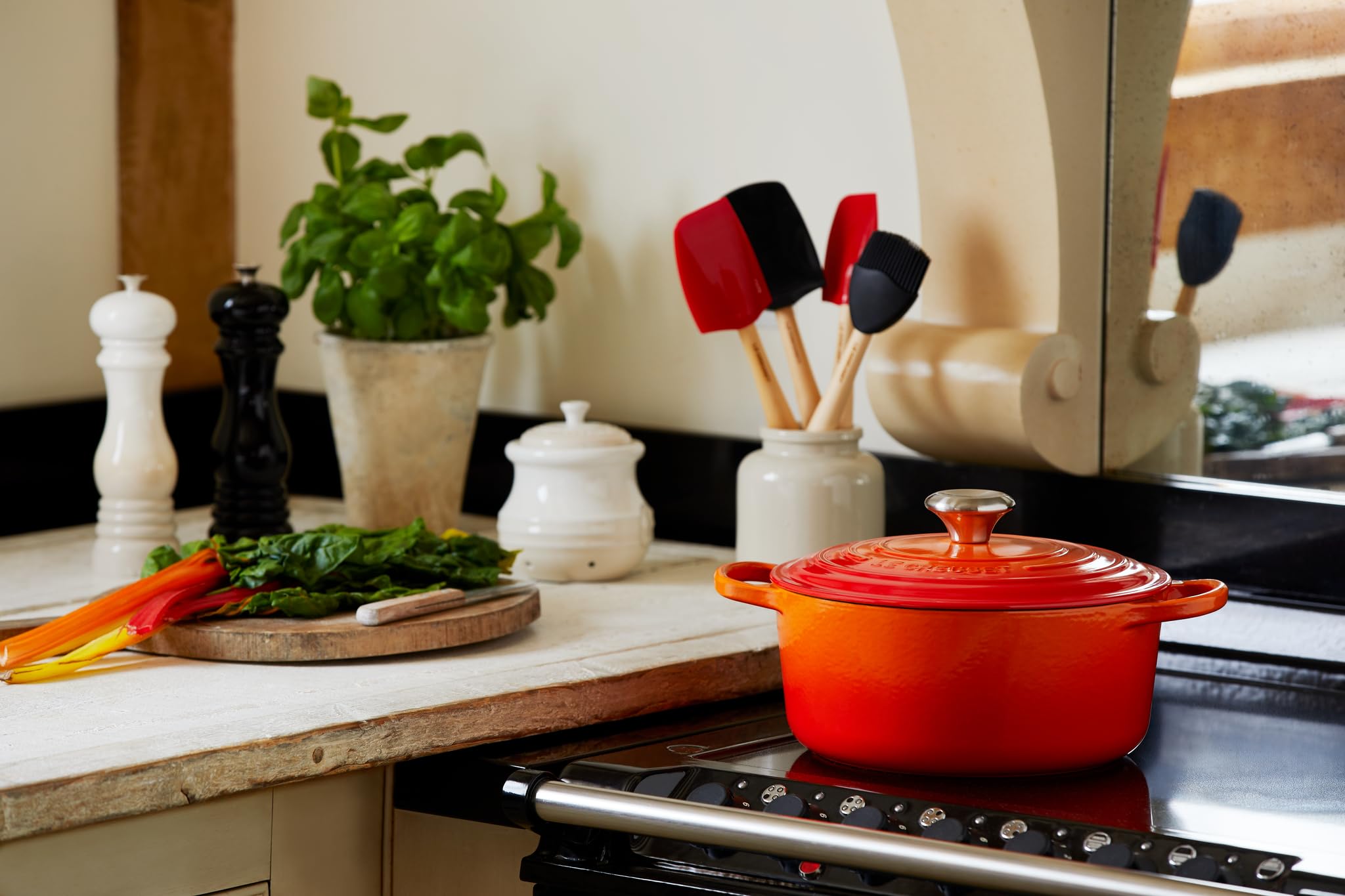 Le Creuset Signature round Dutch oven flame in use on stovetop shows even heat for simmering.