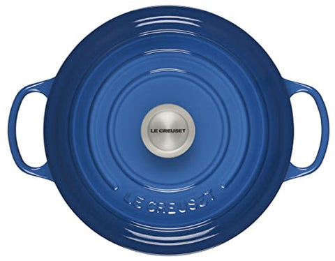 Le Creuset Signature Round Dutch Oven interior light enamel helps monitor browning and moisture.