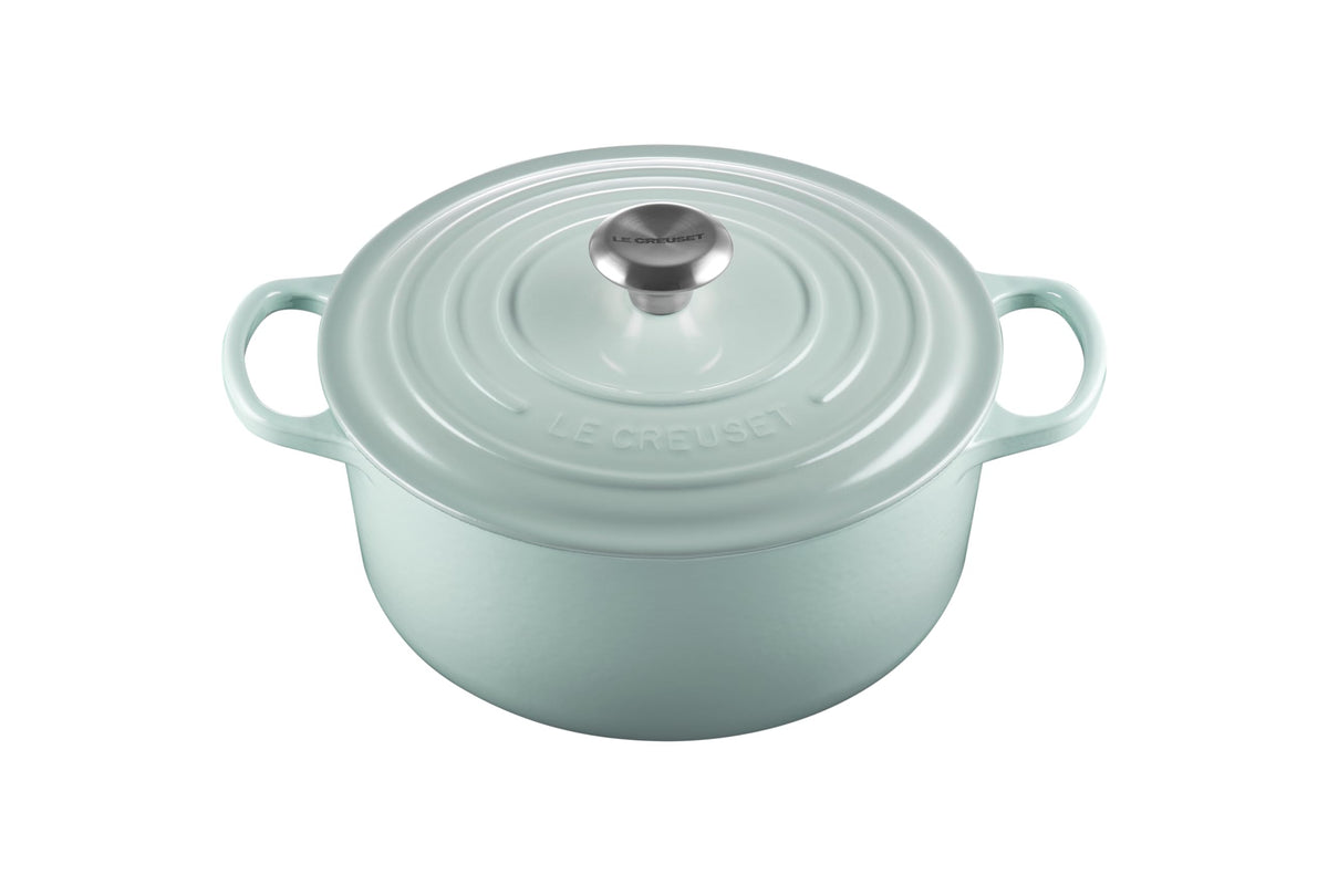 Le Creuset Signature Round Dutch Oven Sea Salt with lid on, durable enamel finish in focus