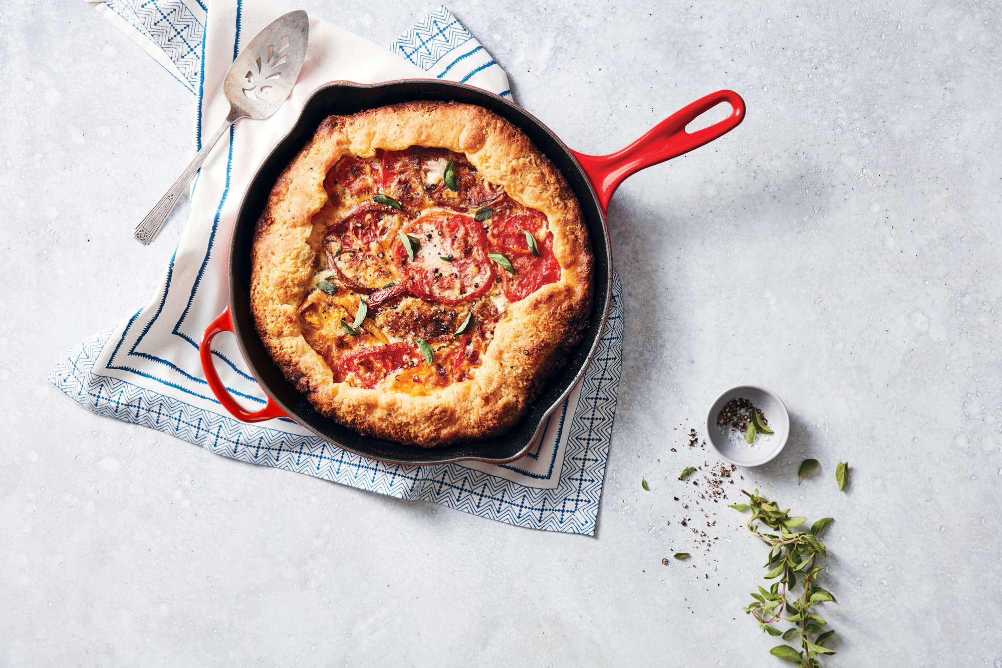 Le Creuset 9-inch skillet in Cerise on the stove showing durable enamel and versatility