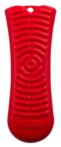 Le Creuset silicone Cool Tool handle in cerise offers a secure grip on hot cookware.