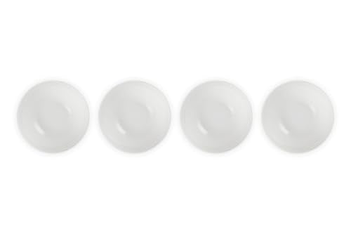 Le Creuset white bowls on table setting for elegant dining and color.