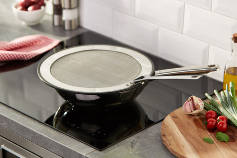 Le Creuset steel-mesh splatter guard vents steam and keeps foods crisp.
