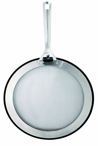 Le Creuset universal-fit splatter guard protecting pan and reducing mess.