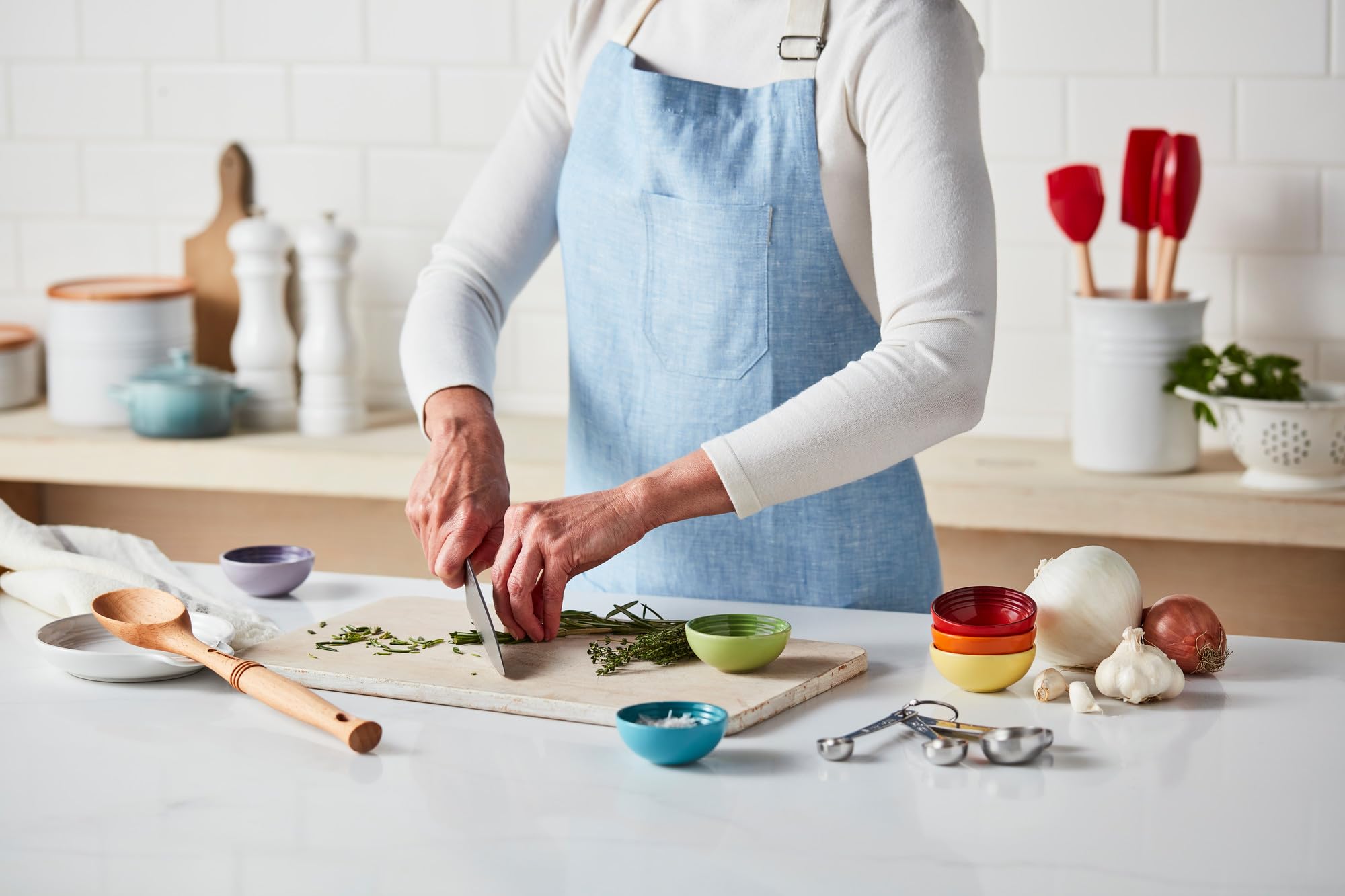 Le Creuset Artichaut stoneware spoon rest offers easy cleaning on a busy table.