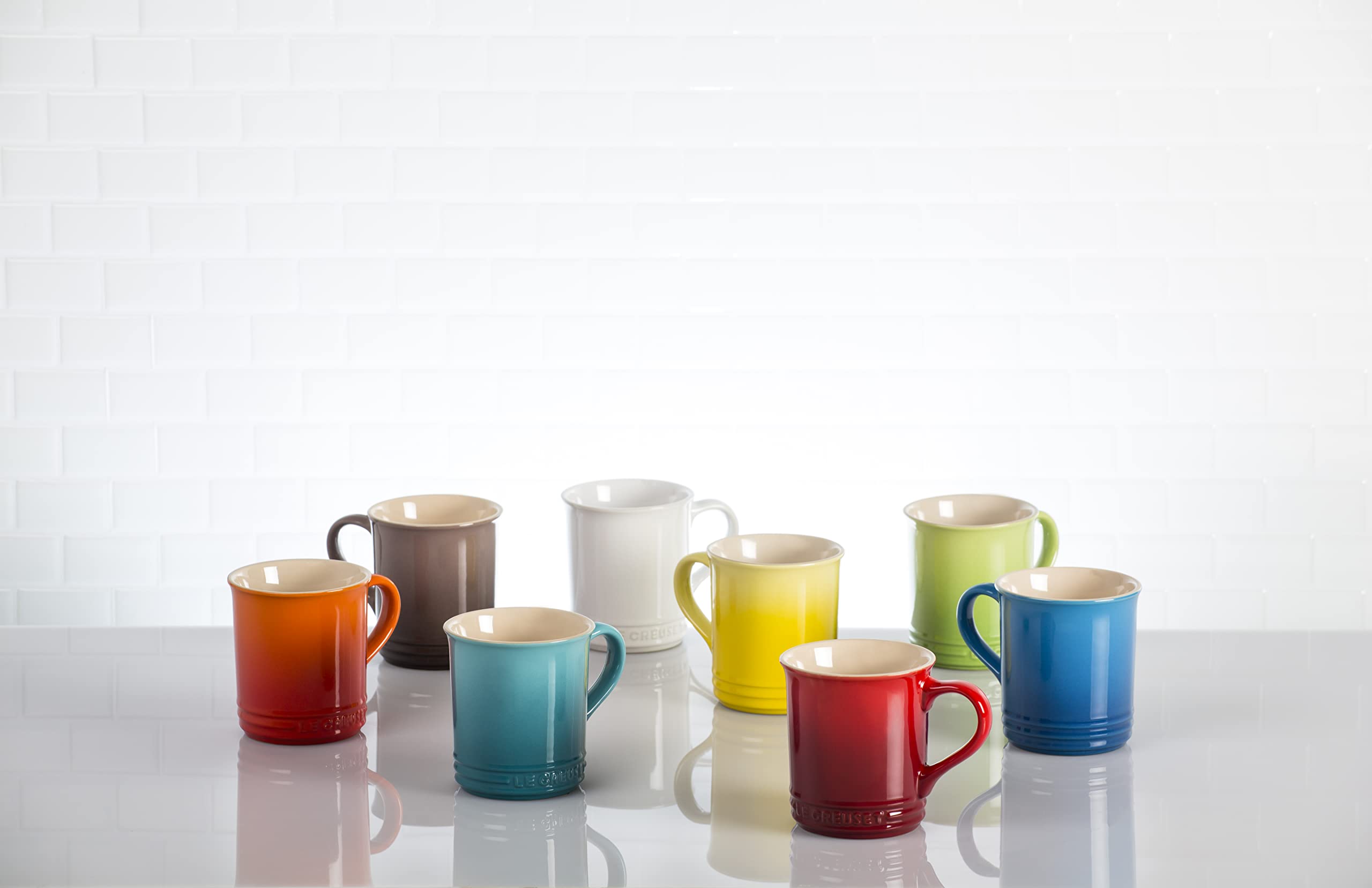 Le Creuset Cerise collection of four mugs on a surface