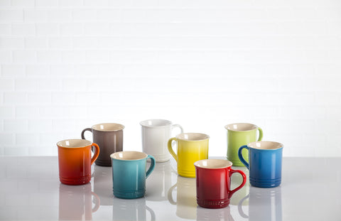Le Creuset Cerise collection of four mugs on a surface