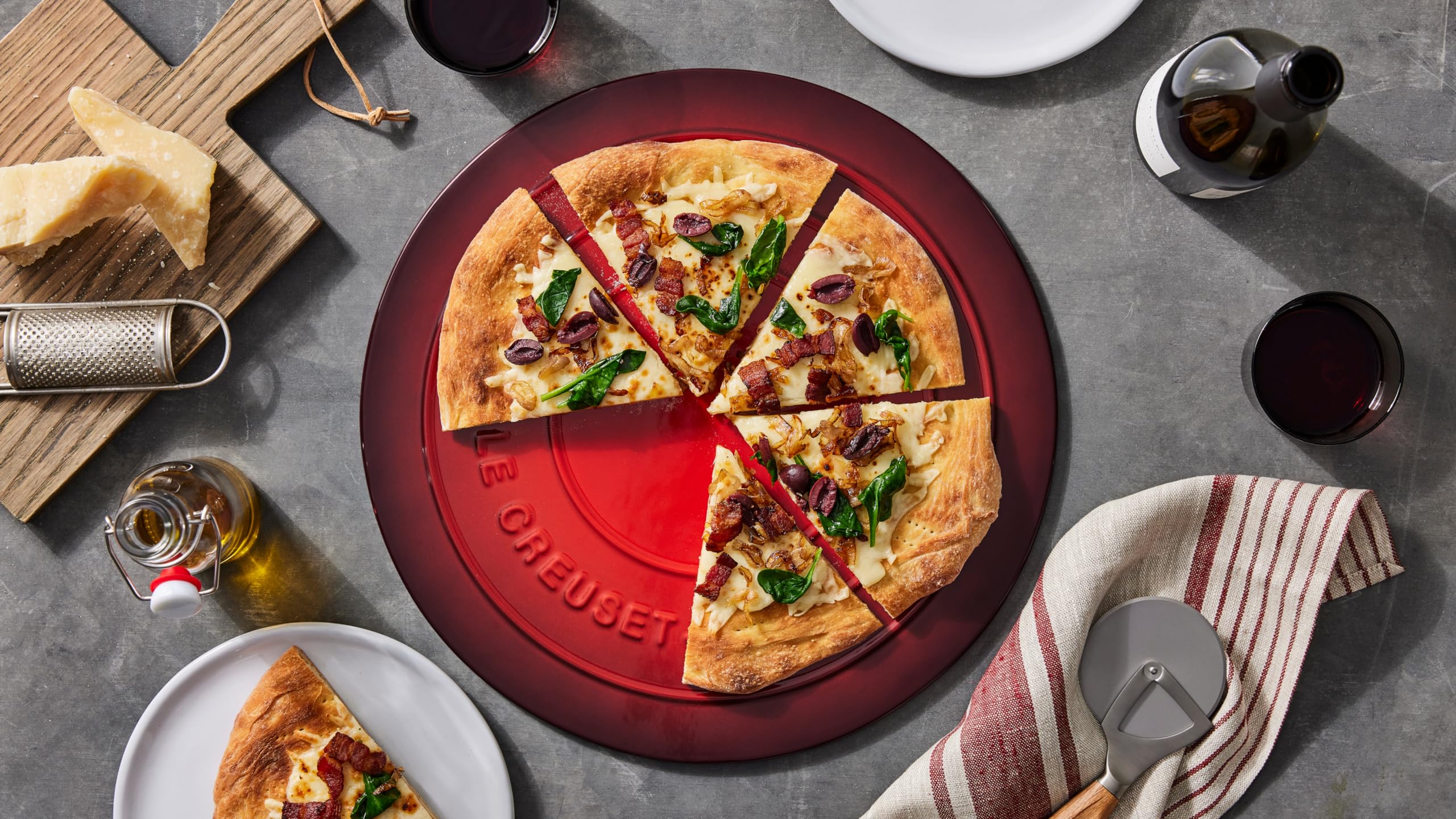 Le Creuset round pizza stone retains heat for serving from oven to table