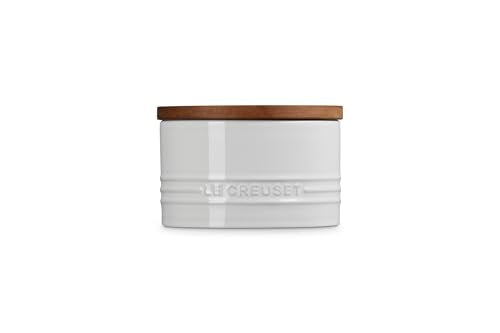 Le Creuset white storage canister with enamel finish resists moisture for a tidy pantry.