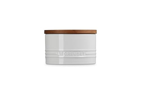 Le Creuset white storage canister with enamel finish resists moisture for a tidy pantry.