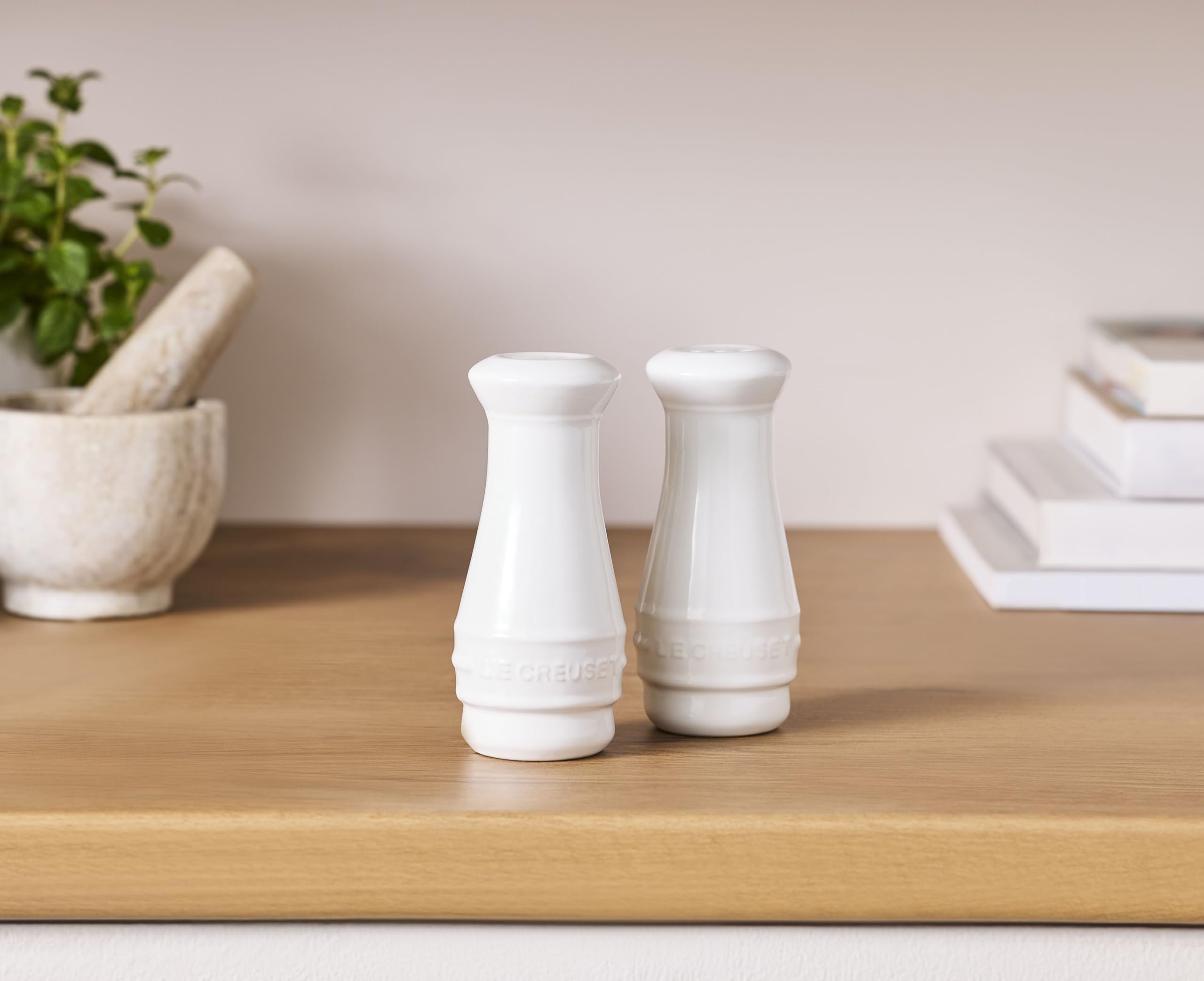 Le Creuset two-piece set—elegant white stoneware for table and kitchen use.