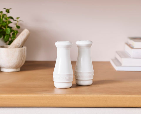 Le Creuset two-piece set—elegant white stoneware for table and kitchen use.