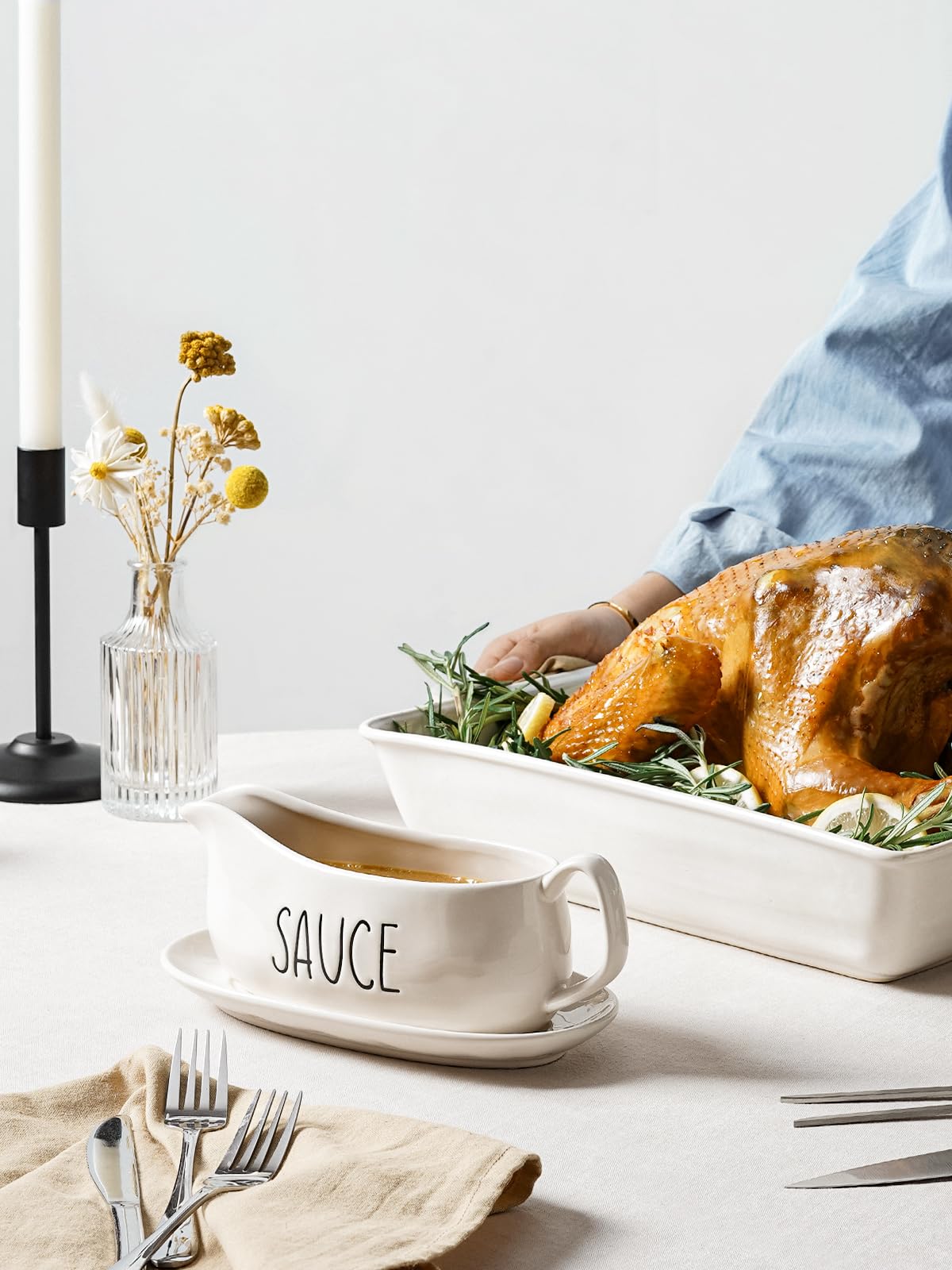 LE TAUCI gravy boat with saucer stand displayed on oyster white glaze.