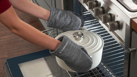 Le Creuset mini oven mitts feature a soft terry interior for comfortable grip.