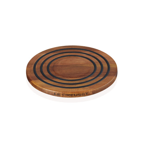 Le Creuset trivet with top silicone rings provides cushioned, heat-resistant support.