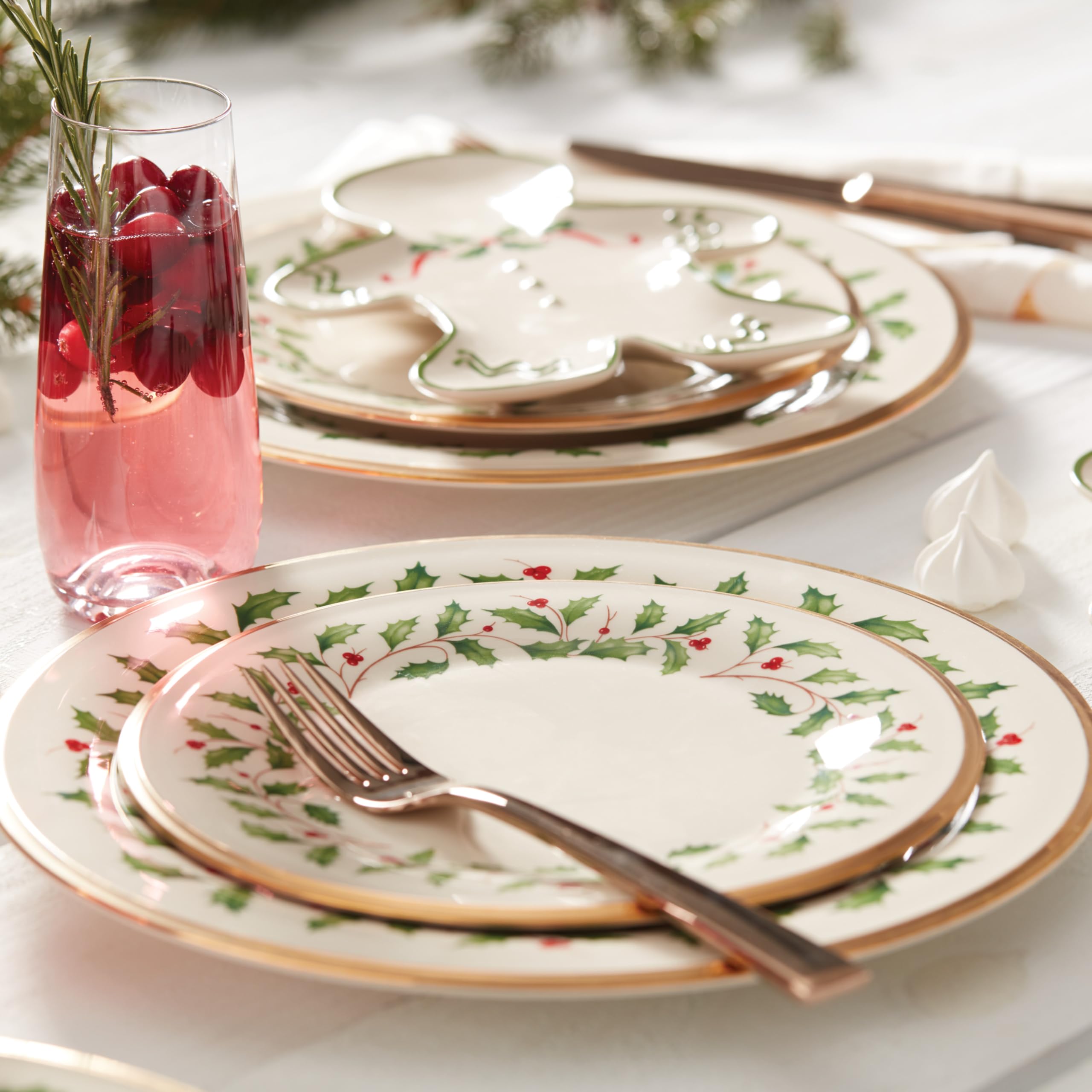Lenox Holiday teacup with holly sprigs and gold trim for refined beverages.