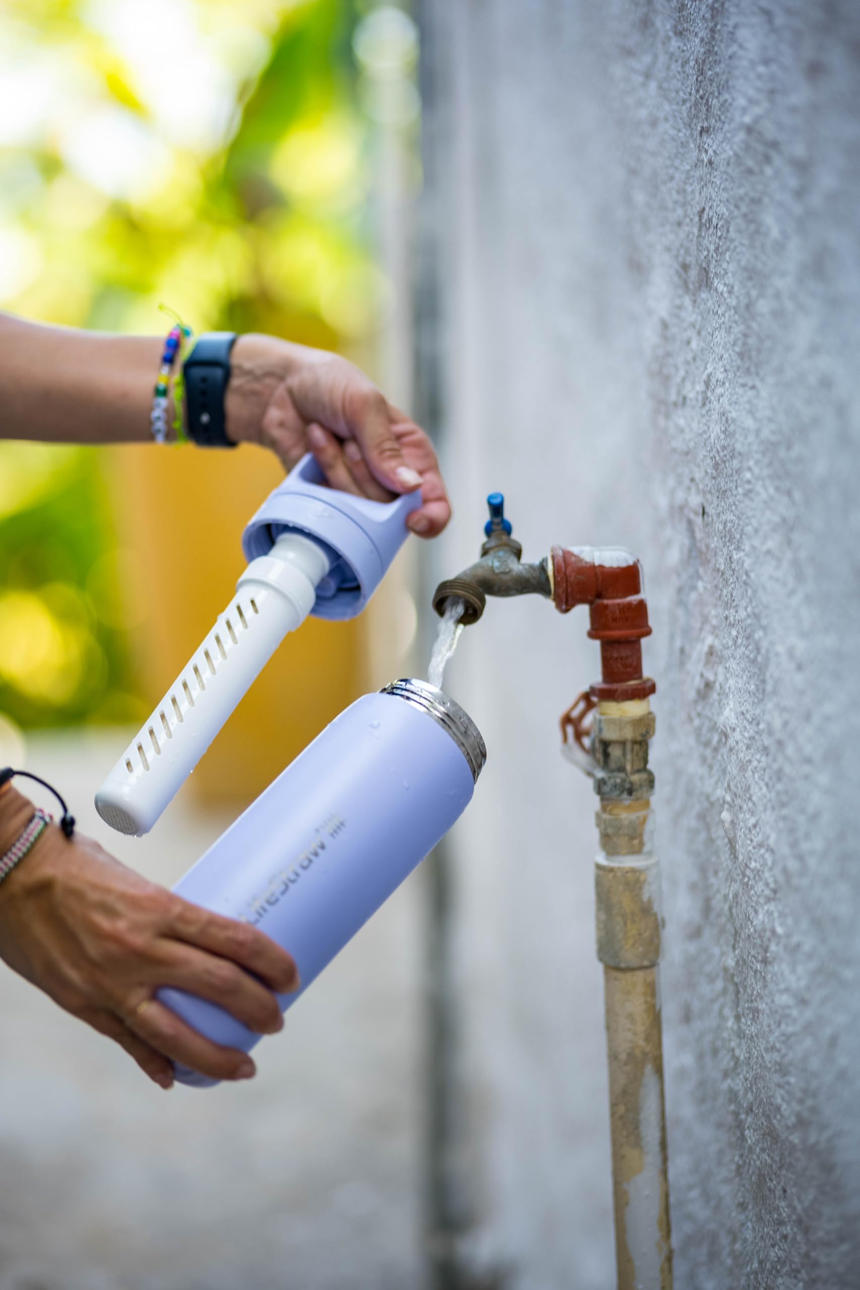 LifeStraw Go Series pour-spout use demonstrating easy sipping while filtered