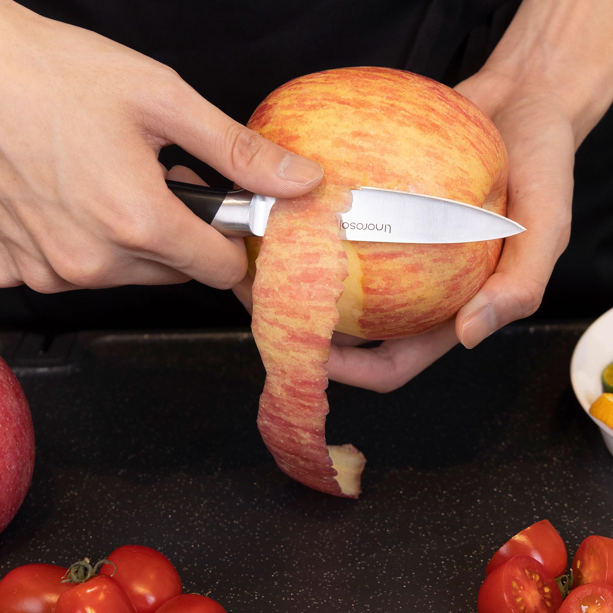 Linoroso Classic paring knife in-use peeling and trimming fruits.