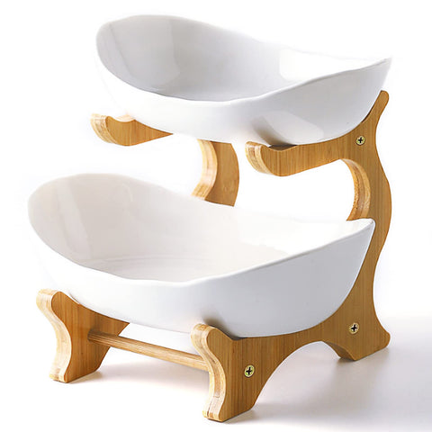 Liywall two-tier ceramic fruit bowl on bamboo stand for stylish countertop storage.