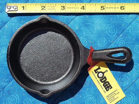 Lodge Mini Skillet 3.5 Inch Cast Iron on stove for quick searing and even heat.