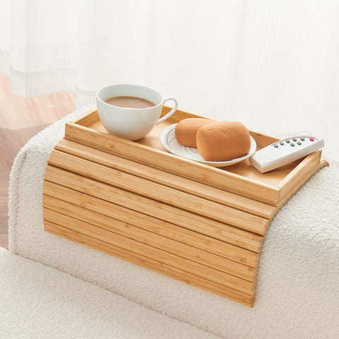 LOVYANXUE Bamboo Sofa Arm Tray on a sofa armrest with spill-prevention edge keeps drinks within reach.