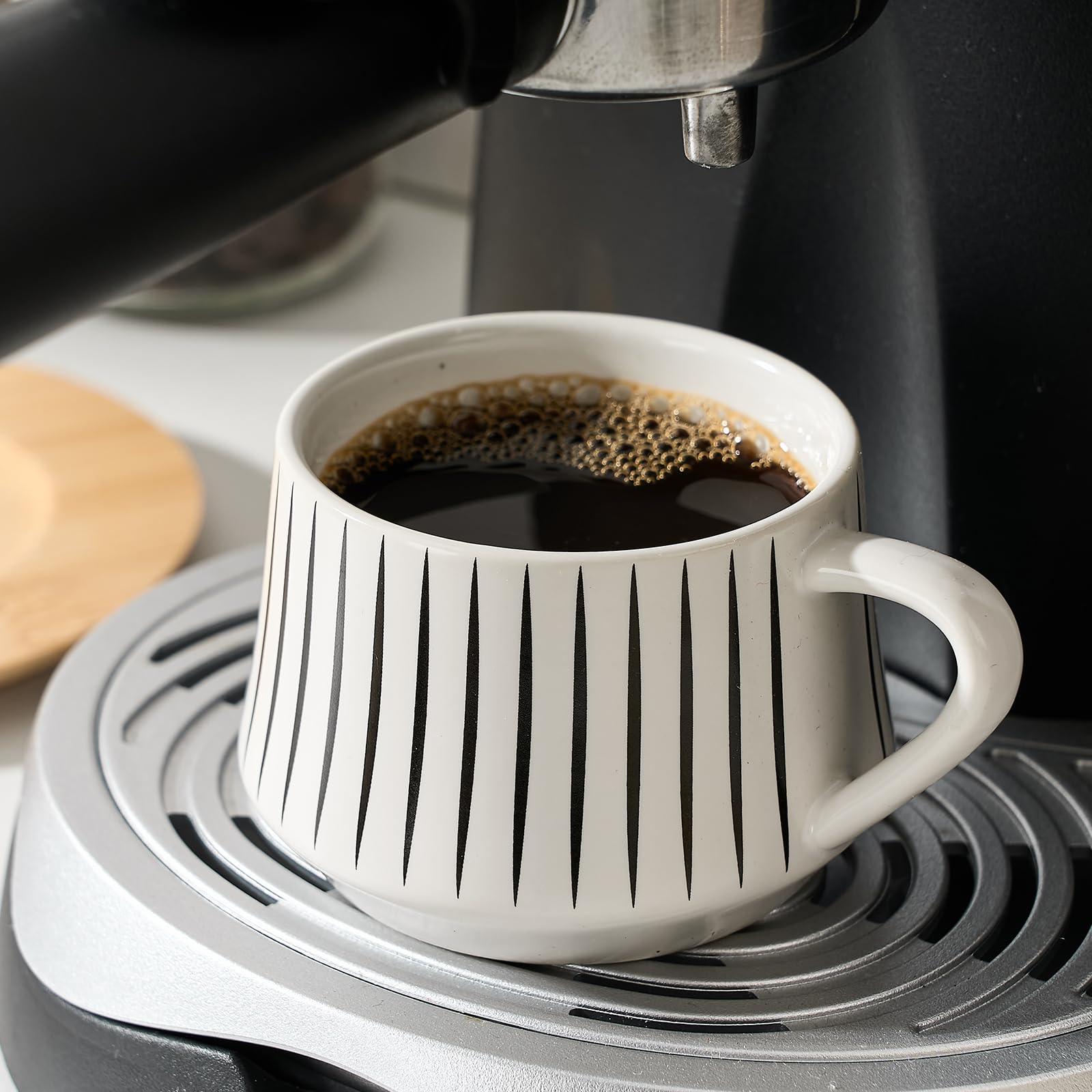 LUKA stackable espresso cups arranged with metal frame for space-saving organization.