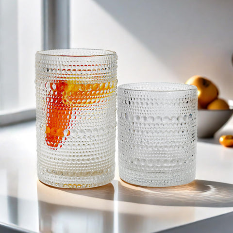 Lumkit glasses with cocktails illustrate versatile use for whiskey, juice, or milk.