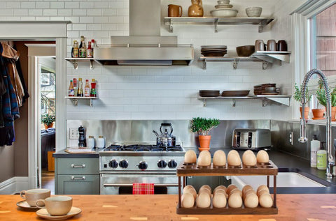 Lurockie Acacia egg rack resting on a fridge top to save counter space.