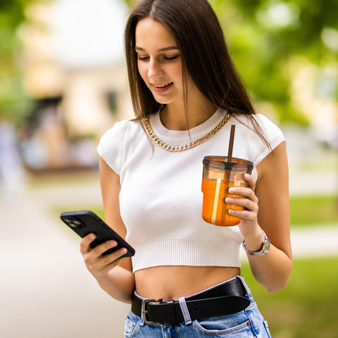 Luxfuel amber tumbler outdoors, perfect for picnics and camping hydration.