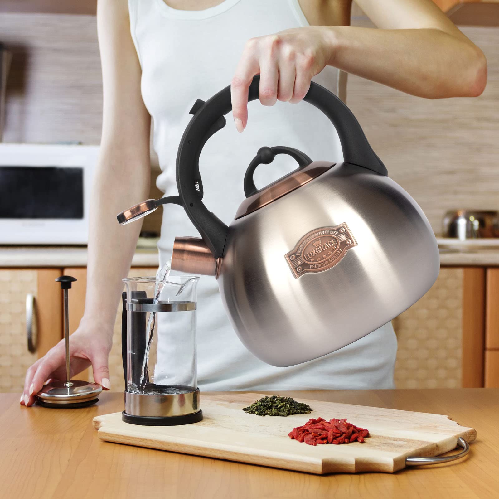 LUXGRACE teal kettle on stove demonstrates induction compatibility.