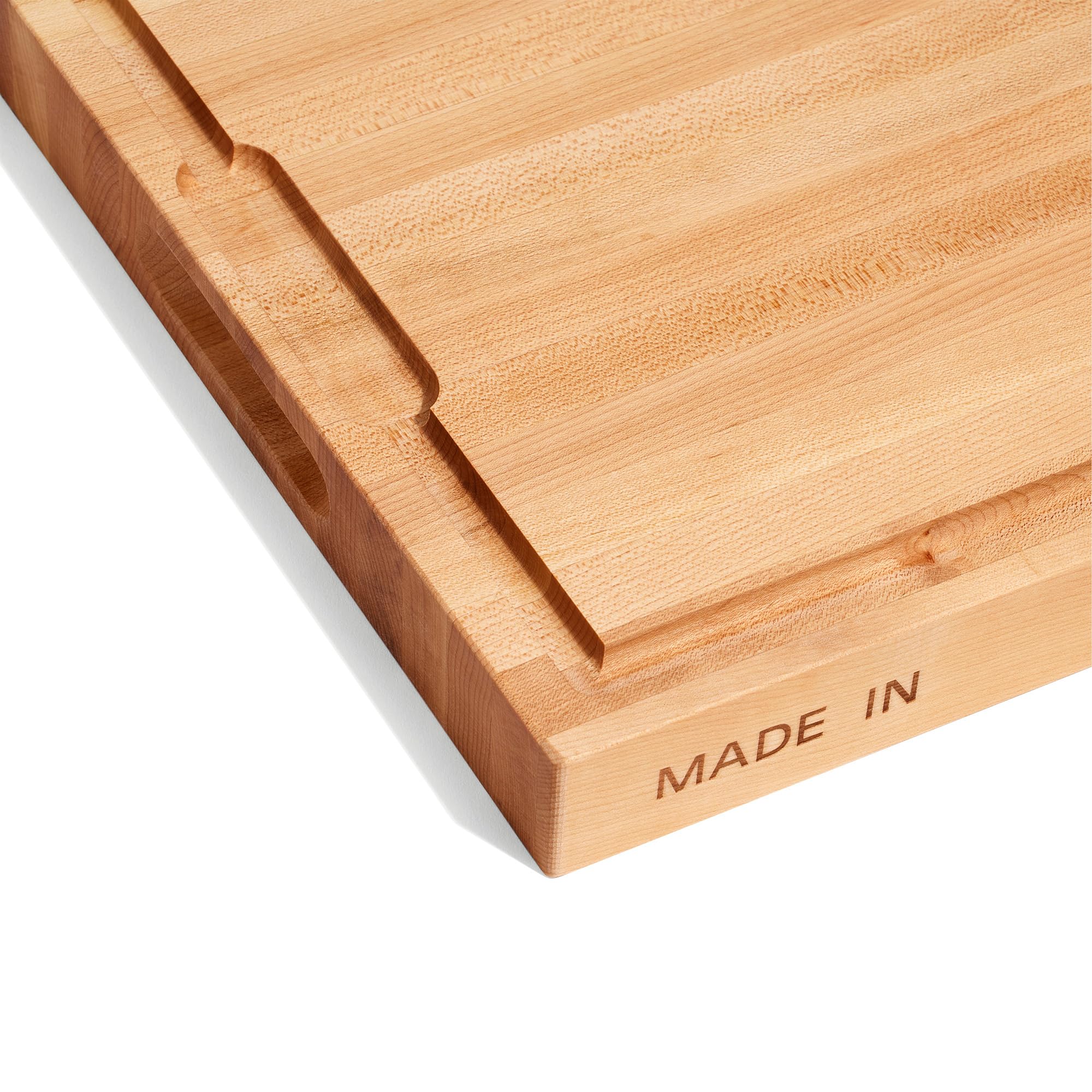 Made In butcher block shows juice groove on the side for cleaner slicing.