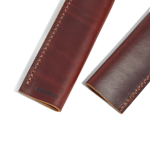 Close-up of Made In leather handle covers hand stitching shows craftsmanship