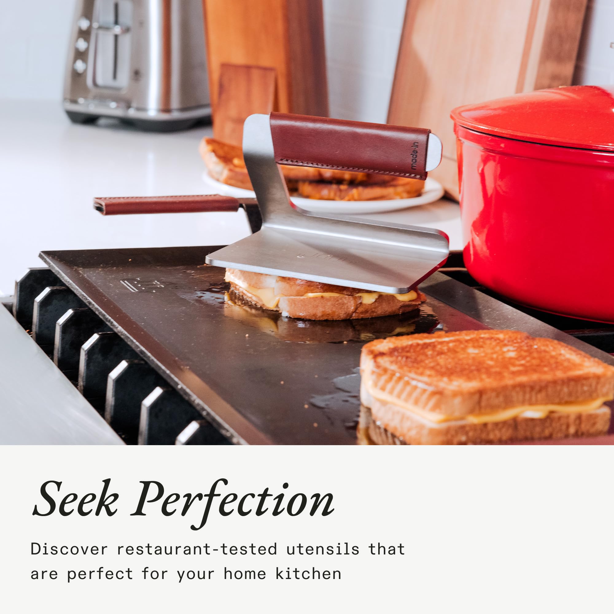 On grill press handle, Made In leather cover provides protective grip and control