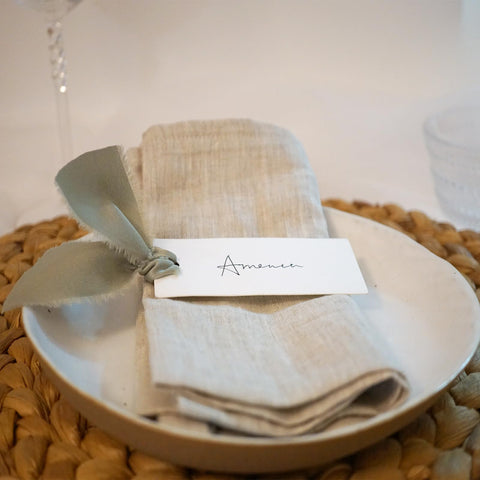 Ribbon detail on Maegmew dusty green cards enhances table coordination