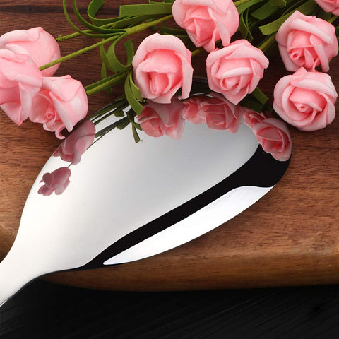 Magatu polished mirror-finish serving spoons for an elegant table presentation.
