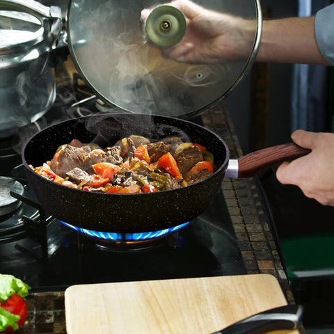 Tempered glass lids on MAISON ARTS cookware for monitoring without heat loss.