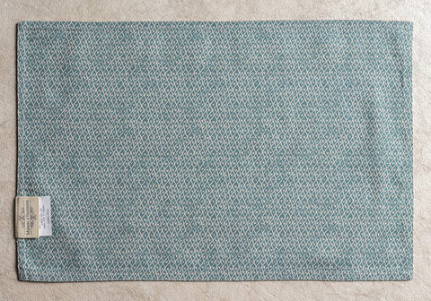 European motif prints on Maison d'Hermine placemat for elegant dining ambiance.
