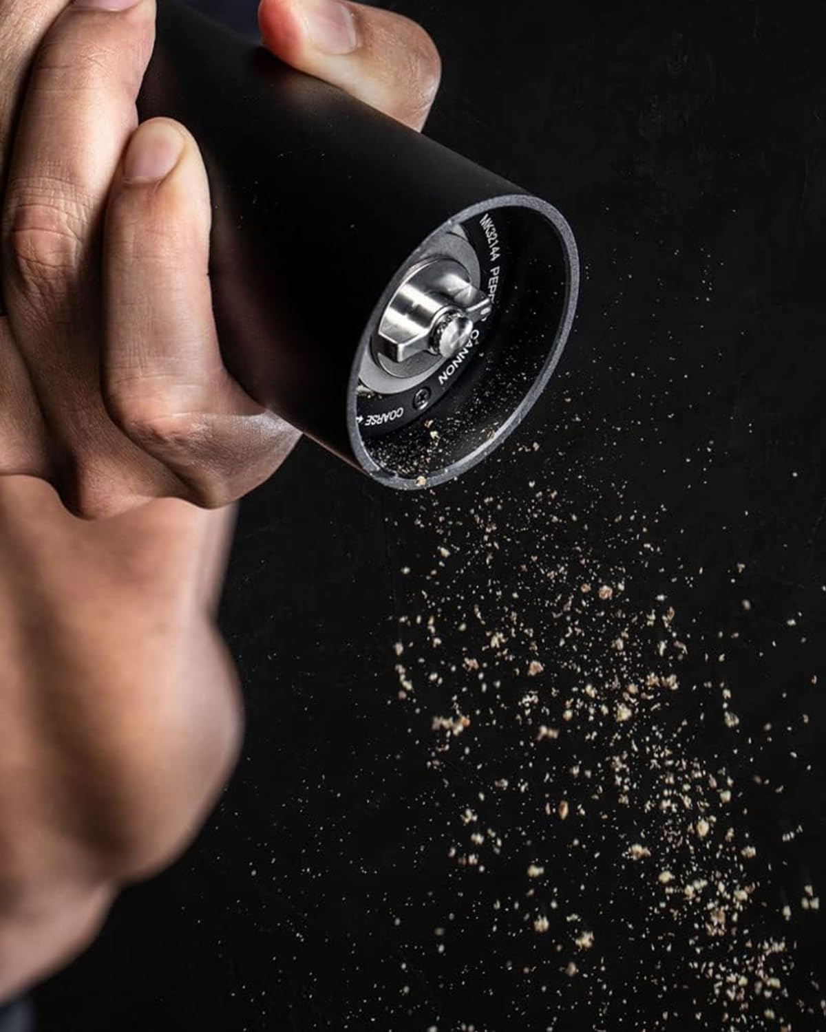 MANNKITCHEN Pepper Cannon side action demonstrates high-output grinding for fast seasoning.
