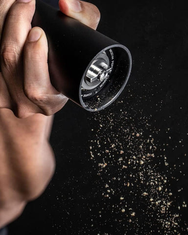 MANNKITCHEN Pepper Cannon side action demonstrates high-output grinding for fast seasoning.
