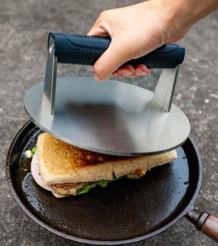 Silicone handle stays cool, enhancing grip during grilling.
