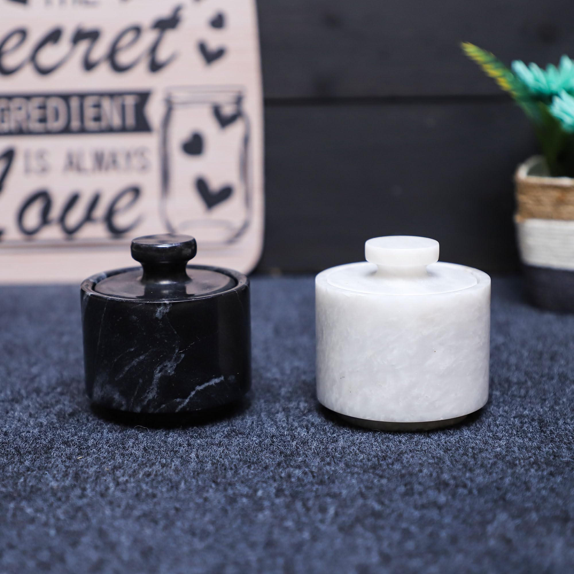 Marble Hives marble salt holder with lid sits beside spices on a bright counter.