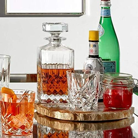 Elegant entertaining setup featuring decanter and two glasses on a home bar.