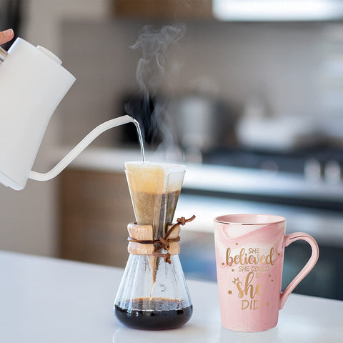 Maustic mug displays golden lettering, suggesting encouragement for daily use.