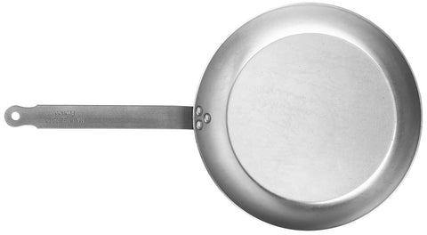 Mauviel M'Steel on induction stove demonstrating versatility across cooktops.