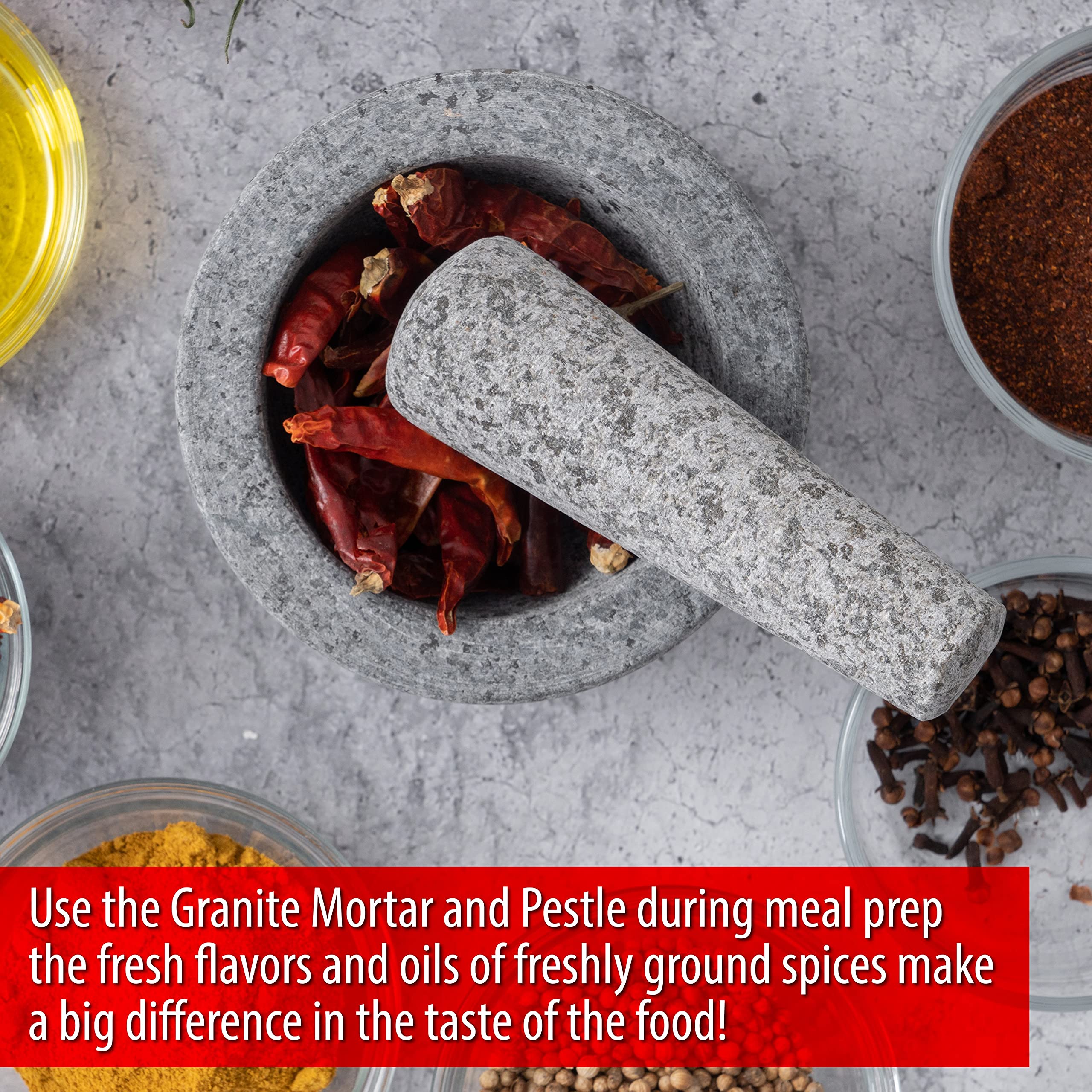Maxam Grey mortar and pestle in action, releasing aromas from ground spices.